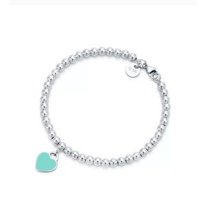 Tiffany & Co. Silver Bracelet with Blue Heart Charm